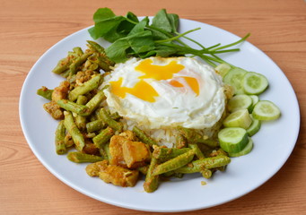 spicy stir fried yard long bean with fat pork curry and creamy egg yolk on rice