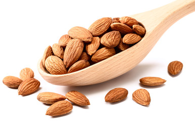 dry almond in the wooden spoon on white