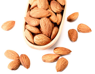 dry almond in the wooden spoon on white