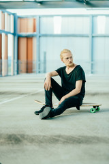 Portrait of Young Long Haired Man with Longboard
