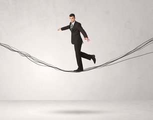 Sales person balancing on drawn ropes