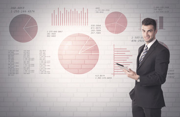 Pie charts and numbers on wall with salesman