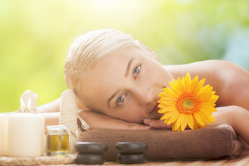 Obraz na płótnie Canvas Blonde woman lying on a lounger having a massage