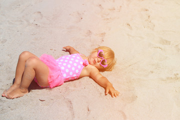 cute little girl play on summer beach