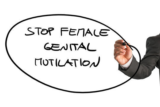 Man writing a sign Stop Female Genital Mutilation