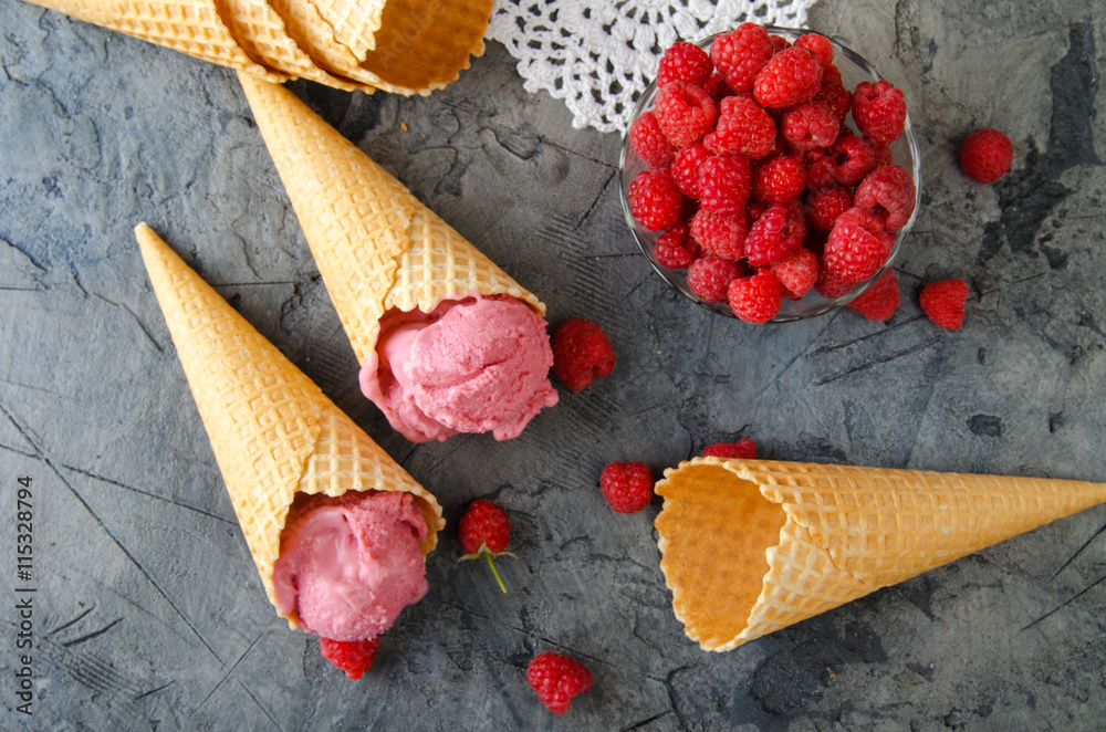 Leinwandbilder raspberry ice cream with ice cream cones on stone table. top view.