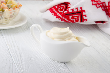 Mayonnaise on a wooden table. Russian style