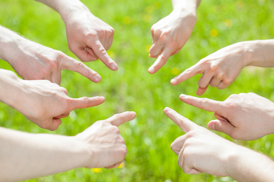 Hands pointing at the centre