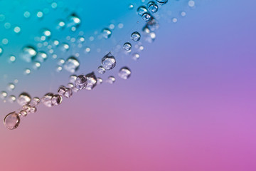 Drops of dew  in close-up. Abstract colorful background.