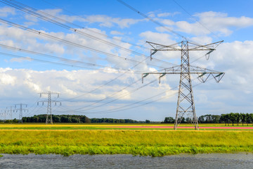 Power lines and pylons in a colorful Dutch polder landscape