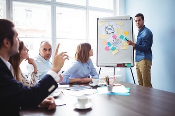 Speaker calling colleague with hand raised during meeting