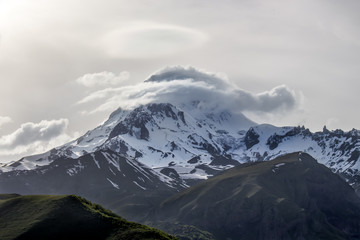 Snow peak of Mount Kazbek in the evening. Georgia