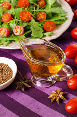 Salad of arugula and tomatoes with oil and herbs.