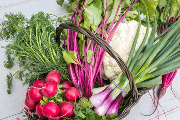 Organic vegetable in a basket on a white kitchen table