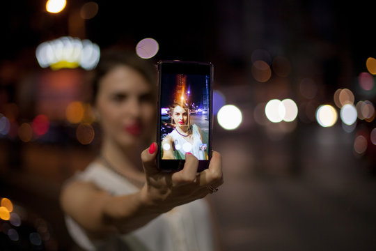 Young woman taking selfie in the city
