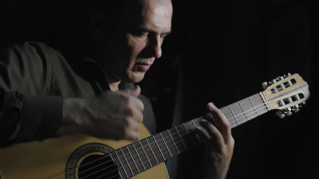 Man masterfully plays on classical acoustic guitar