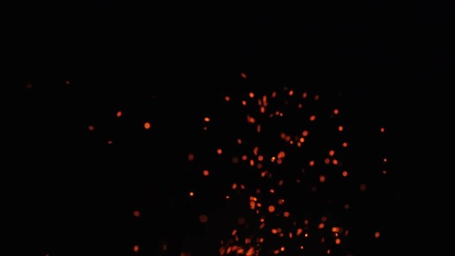 fire sparks from campfire over black background