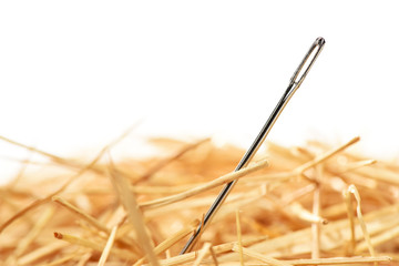 Closeup of a needle in haystack. Isolted on white background - obrazy, fototapety, plakaty