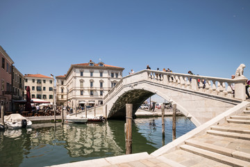 Fototapeta na wymiar Typical bridge across a canal in Chioggia, Venice, Italy.