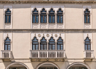 Decorated arched windows of a medieval palace.
