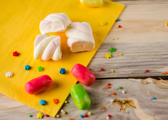 Multi-colored candy on a wooden surface.