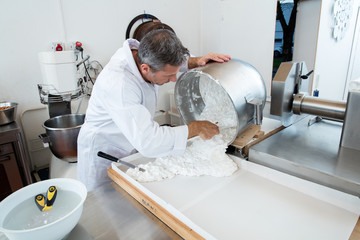 pouring nougat with Italian white dough with roasted almonds