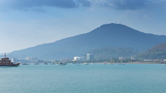 FullHD video - Panning across a beautiful, busy harbor with yachts, sailboats and tour boats, as an enormous eagle statue stands overlooking the bay.