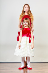 Mother and daughter posing together