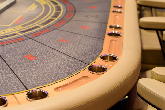 closeup of poker table with cupholders