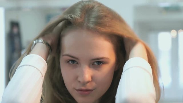 Brown-haired without make up smiling on the camera