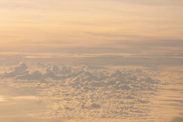 Flying above the clouds at twilight time.