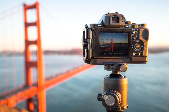 camera with gold gate bridge over water