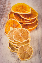 Vintage photo, Slices of dried lemon and orange on old wooden background