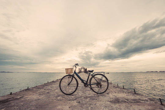 Vintage bicycle on concrete pier, vintage tone, soft focus