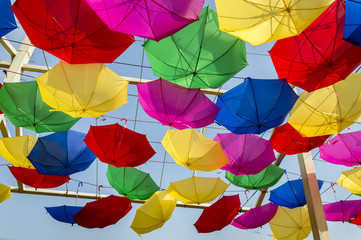 Fototapeta na wymiar Reversely swinging umbrellas