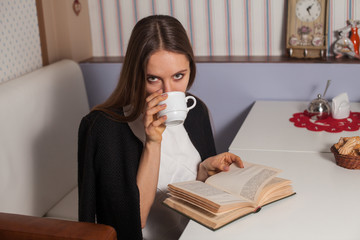 Woman with book and tea