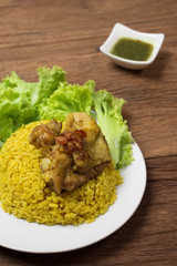Thai chicken biryani (Khao Mok Gai) or Yellow curry rice Thai Food Style on wood background