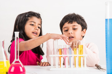 4 year old indian boy and girl doing science experiment, science Education. asian kids and science experiments, chemistry experiment, indian kids and science experiments, indian kids and science lab