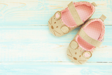baby shoes on a blue rustic background