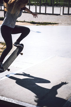 Skateboarding woman practicing at skatepark