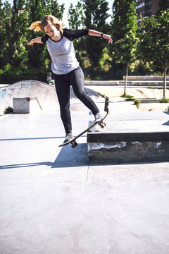 Skateboarding woman practicing at skatepark