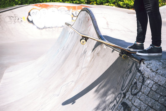 Skateboarding woman practicing at skatepark