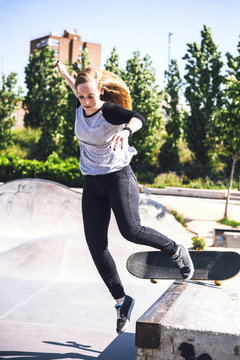 Skateboarding woman practicing at skatepark