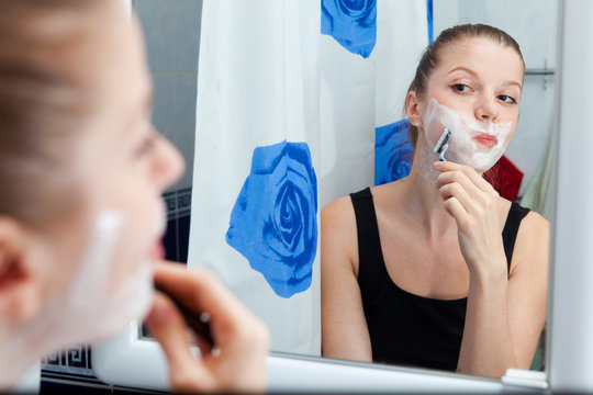 Girl shaving in bathroom