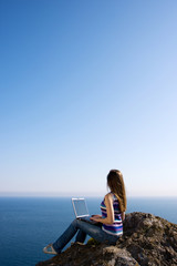 woman with laptop and sea