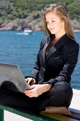 woman with laptop near the  sea