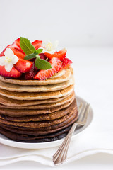 Ombre chocolate pancakes with fresh strawberry on white backgrou