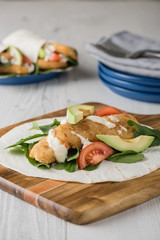 Fish finger wraps with avocado and tomato