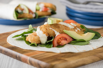 Fish finger wraps with avocado and tomato