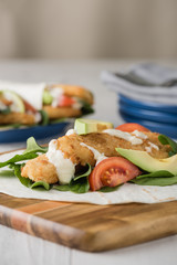 Fish finger wraps with avocado and tomato